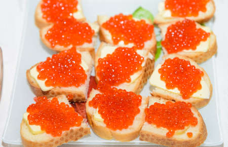 sandwich with red caviar, butter and herbsの写真素材