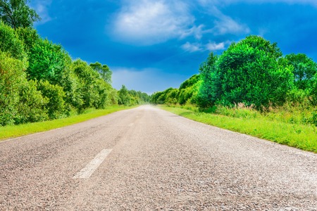 the road between the field goes awayの写真素材