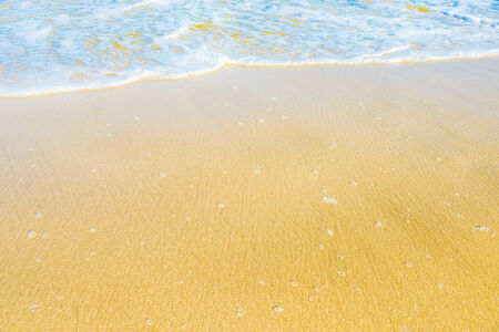sandy beach and calm blue sea surfの写真素材