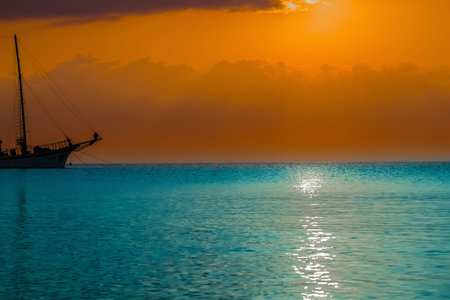 beautiful sunrise sun in the clouds on a quiet calm seaの写真素材