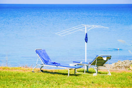 beach with thatched umbrellas on the shore of the island of Cyprusの写真素材