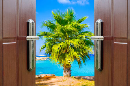 open white door with a view of the sky with the sun skyの写真素材