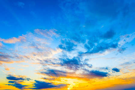 Decline in clouds of the sun with beams backgroundの写真素材