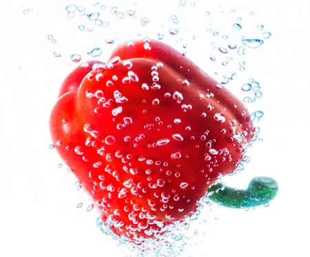 peppers in water drops on a white backgroundの写真素材