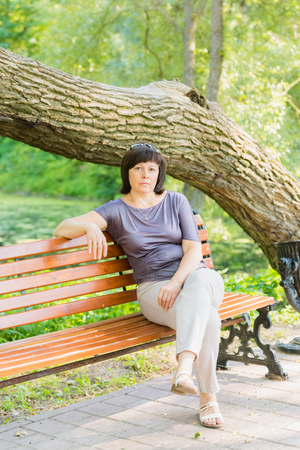 portrait of a middle-aged brunette woman on a background of natureの写真素材