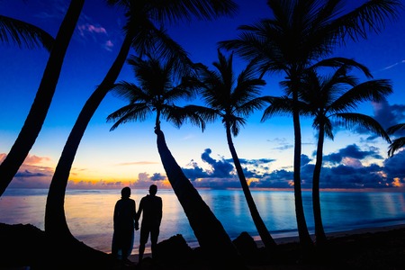 family man and woman on the ocean greet the dawnの写真素材