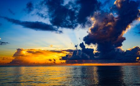 quiet morning sunrise over the ocean cloud skyの写真素材