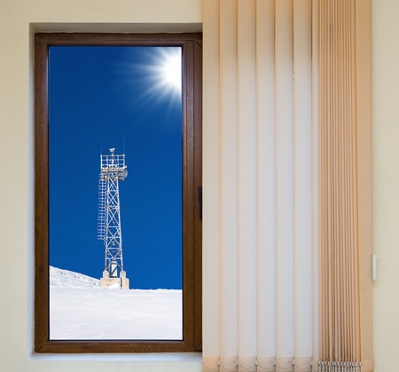wooden window blinds in a house with a beautiful landscapeの写真素材