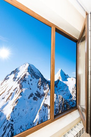 wooden window blinds in a house with a beautiful landscapeの写真素材