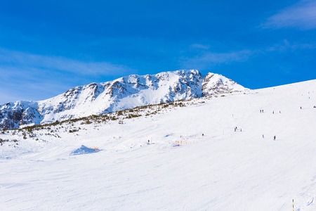 mountain peaks covered with snow illuminated by a bright sunの写真素材