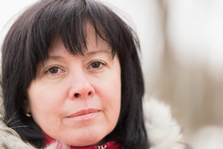 portrait of a middle-aged brunette woman on a background of nature