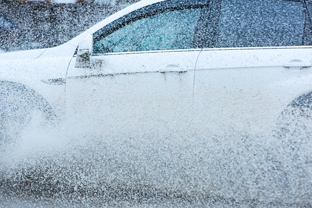 motion car rain big puddle of water spray from the wheelsの写真素材