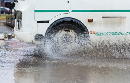 Car rides on big water in the rainの写真素材