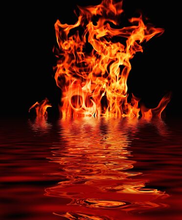 furious raging flames red fire black backgroundの写真素材