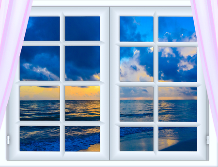 beautiful sunset on the sea view from the window with curtains openの写真素材