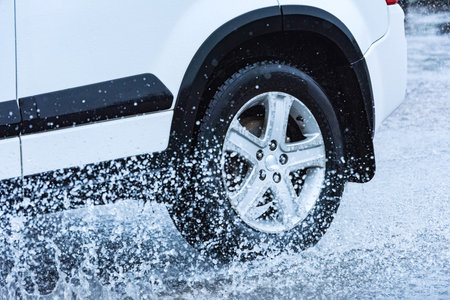 motion car rain big puddle of water spray from the wheels