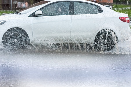 motion car rain big puddle of water spray from the wheels