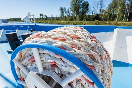 mooring rope is wound on board the ship to berthの写真素材