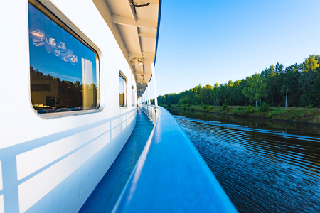 view of the side of a river cruise ship floats on the channelの写真素材