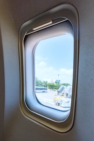 airplane porthole view into open space skyの写真素材