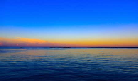 the calm sea in the sunset sky beautifullyの写真素材