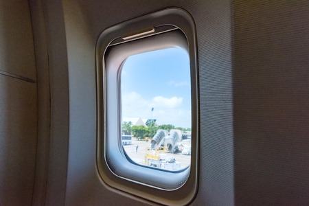 airplane porthole view into open space skyの写真素材
