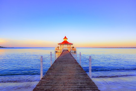 gazebo with a bridge on the coast of the seaの写真素材