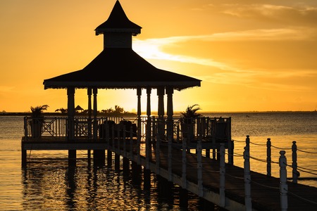 gazebo bridge in the sea at sunset evening skyの写真素材