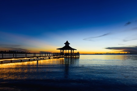 gazebo bridge in the sea at sunset evening skyの写真素材