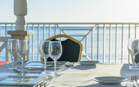 served a festive table in the gazebo near the sea at sunsetの写真素材