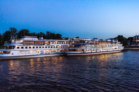Two cruise ships anchored in the harbor at nightの写真素材