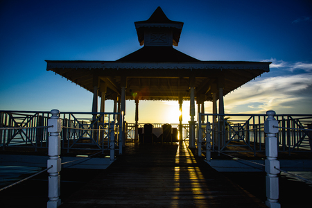 gazebo bridge in the sea at sunset evening skyの写真素材
