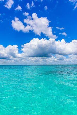 landscape view of the open blue sea blue sky with white cumulus clouds summerの写真素材