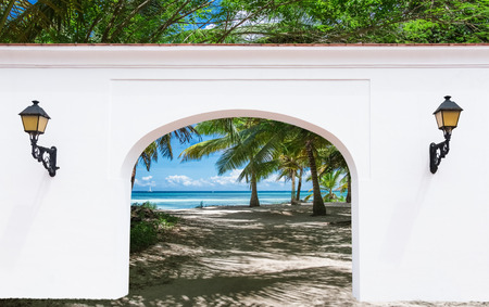 open doorway arch door on the alley of palm trees on a sunny summer dayの写真素材