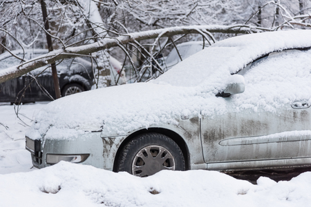 car is parked tunes with a thick layer of snow blizzard cold winterの写真素材