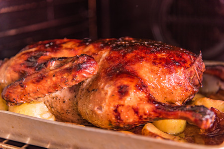 Festive Christmas goose with fried potatoes and crisp in the ovenの写真素材