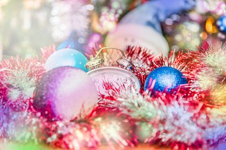 New Year Clock lie in brightly colored shiny tinselの写真素材