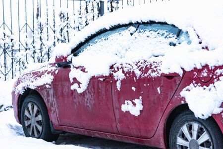 car is parked tunes with a thick layer of snow blizzard cold winterの写真素材