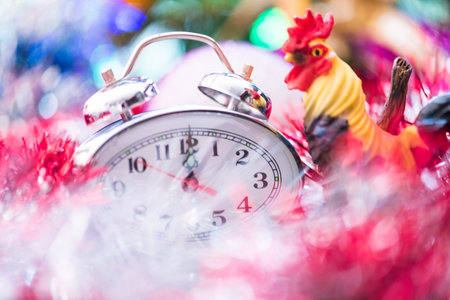 New Year Clock lie in brightly colored shiny tinsel