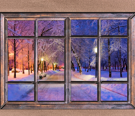 Old wooden window view of the winter landscape with a lanternの写真素材