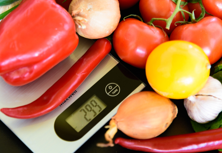 Assorted group of vegetables on a dark kitchen tableの写真素材