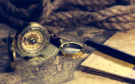 compass and magnifying glass lie on the topographic map