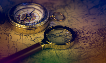 compass and magnifying glass lie on the topographic mapの写真素材