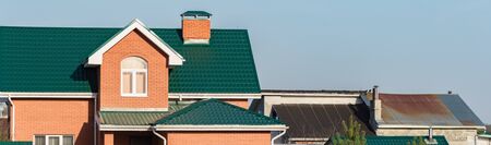 chimney on the roof of the house against the blue skyの写真素材