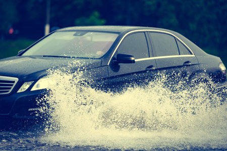 motion car rain big puddle of water spray from the wheels