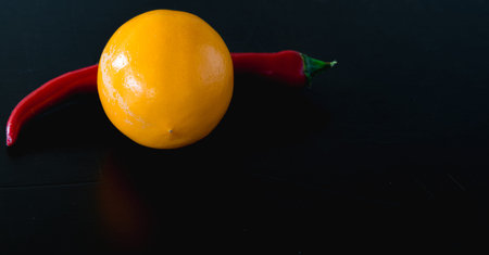 Lemon and pepper on the table black backgroundの写真素材