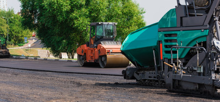 Laying a new drill bitumen asphalt in the city