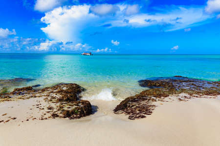 sandy beach and calm blue sea surf caribbean dominicanの写真素材