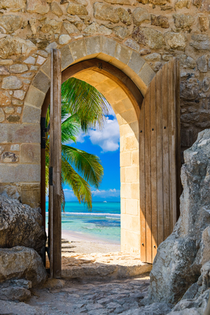 old wooden arch in the fortress with open doors view of the Caribbean Seaの写真素材