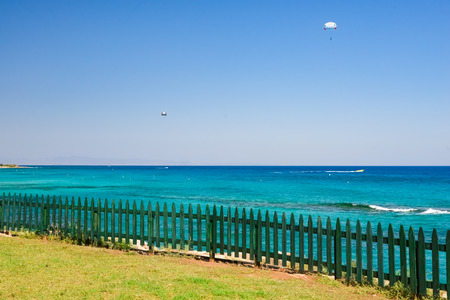 a green wooden fence fence to the shore of the Mediterranean Seaの写真素材